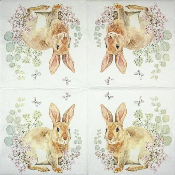 a paper napkin with rabbits and flowers