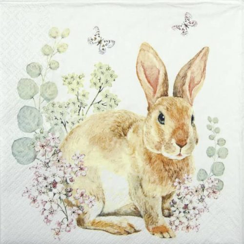 a paper napkin with a rabbit and flowers