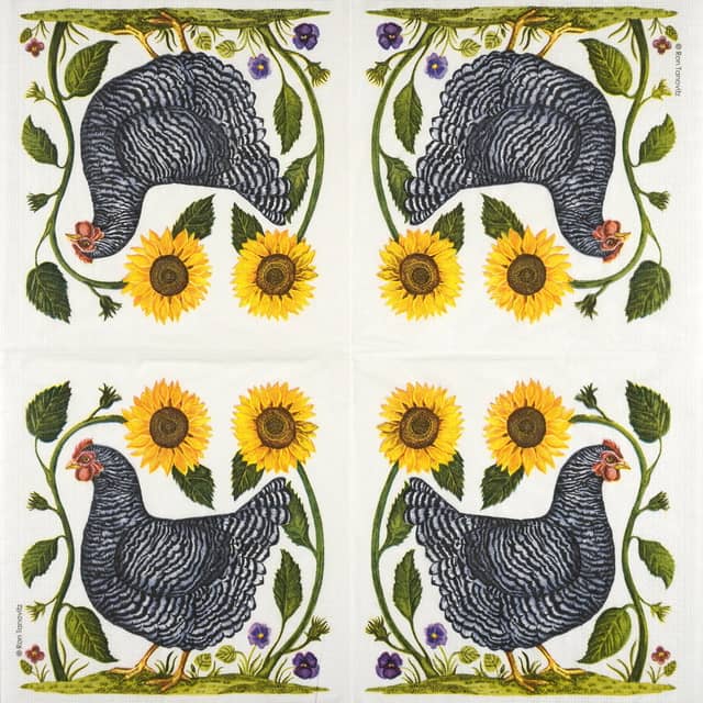 The image shows an embroidered design of a black and white chicken walking to the left. The chicken is surrounded by green foliage, with two large sunflowers above and small purple flowers below. The background is plain white fabric.