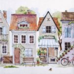 Paper Napkin Cottages: Close-up showing a row of picturesque European townhouses and shops with a bicycle and awning