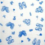 Close-up view of a single light blue baby napkin for creative crafts, focusing on the high-quality decoupage napkins texture and baby shoes design.