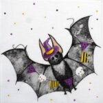 Close-up detail of the Bat Halloween napkin showing a painted bat wearing a purple witch hat on a white background.
