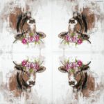 Open napkin showing repeated painted cow motif with floral crowns.