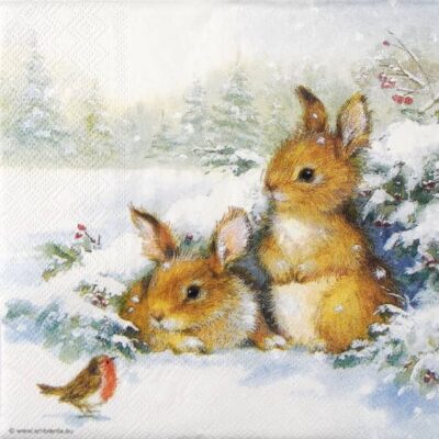 Two rabbits sitting in the snow with a robin nearby, surrounded by evergreen foliage and red berries.